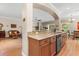 Open concept kitchen with granite countertop bar overlooking the living room at 4210 Arlington Ridge Blvd, Leesburg, FL 34748