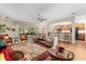 Bright, open-concept living room with hardwood floors and sliding glass doors to outdoor living space at 4210 Arlington Ridge Blvd, Leesburg, FL 34748