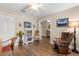 Office room features a bookcase, wood floor, and ceiling fan at 4210 Arlington Ridge Blvd, Leesburg, FL 34748