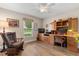 Bright office space with built-in desk and cabinets, plus a comfortable rocking chair at 4210 Arlington Ridge Blvd, Leesburg, FL 34748