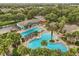 Overhead shot of a resort-style pool and recreation area surrounded by lush landscaping and mature trees at 4210 Arlington Ridge Blvd, Leesburg, FL 34748