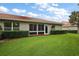 Exterior view showcasing the backyard, lush lawn, and back of the home at 5071 Harbour Dr, Oxford, FL 34484