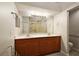Bathroom featuring double sinks, large mirror, and enclosed shower at 5071 Harbour Dr, Oxford, FL 34484