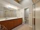 Bathroom with double sink vanity, shower, and tile floor at 5071 Harbour Dr, Oxford, FL 34484