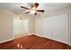 Bedroom featuring a closet, ceiling fan, hardwood floors and a window at 5071 Harbour Dr, Oxford, FL 34484
