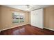 Empty bedroom with hardwood floors, a built-in cabinet, ceiling fan and a window with natural light at 5071 Harbour Dr, Oxford, FL 34484