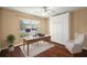 Bedroom with hardwood floors, murphy bed, ceiling fan, and a window with natural light at 5071 Harbour Dr, Oxford, FL 34484