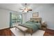 Bedroom with wood floors, ceiling fan, and window with curtains at 5071 Harbour Dr, Oxford, FL 34484