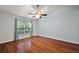 Bright bedroom featuring wood floors, ceiling fan, and window at 5071 Harbour Dr, Oxford, FL 34484