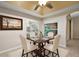 Elegant dining room with a stylish table, four chairs, and bright natural light at 5071 Harbour Dr, Oxford, FL 34484