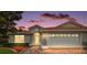 Charming single-story home with a red tile roof, brick driveway, and manicured landscaping at 5071 Harbour Dr, Oxford, FL 34484