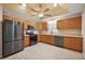 Spacious kitchen featuring stainless steel appliances, ample wood cabinetry, and tile flooring at 5071 Harbour Dr, Oxford, FL 34484
