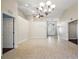 Bright living room with tile floors, high ceilings, chandelier, and double doors at 5071 Harbour Dr, Oxford, FL 34484
