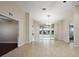 Bright living area with tile floors, arched doorways, and a view of the outdoor lanai at 5071 Harbour Dr, Oxford, FL 34484