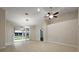 Spacious living area with tile flooring, high ceilings, and a sliding glass door to the patio at 5071 Harbour Dr, Oxford, FL 34484