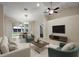 Bright living room featuring stylish furniture, a TV, and a view of the dining area at 5071 Harbour Dr, Oxford, FL 34484