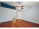 Bedroom with wood floors, ceiling fan, and en-suite bathroom at 5071 Harbour Dr, Oxford, FL 34484