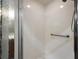 Tiled shower with glass doors and a handheld shower head, providing a clean and accessible space at 5071 Harbour Dr, Oxford, FL 34484