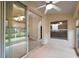 Inviting sunroom featuring tile flooring, a ceiling fan, and views into the home at 5071 Harbour Dr, Oxford, FL 34484