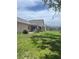 Wide shot of the backyard featuring a partial view of a screened in pool at 5268 Sw 110Th Pl, Ocala, FL 34476