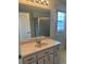 Bathroom vanity with a large mirror, sink, and a shower with glass doors at 5268 Sw 110Th Pl, Ocala, FL 34476