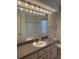 Bathroom vanity with a large mirror, sink, and vanity lighting at 5268 Sw 110Th Pl, Ocala, FL 34476