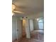 Bedroom with a mirrored closet, doorway to the bathroom, and a ceiling fan at 5268 Sw 110Th Pl, Ocala, FL 34476