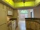 Bright kitchen featuring updated appliances and a vaulted ceiling with decorative skylight, offering an inviting space at 5268 Sw 110Th Pl, Ocala, FL 34476