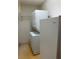 Cozy laundry area featuring a stacked washer/dryer unit, and shelving at 5268 Sw 110Th Pl, Ocala, FL 34476