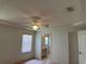 Main bedroom featuring a ceiling fan, neutral walls, and ensuite bathroom at 5268 Sw 110Th Pl, Ocala, FL 34476