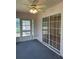 Cozy sunroom featuring tile flooring, ceiling fan, and sliding glass doors, offering a peaceful retreat at 5268 Sw 110Th Pl, Ocala, FL 34476