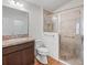The bathroom has a single vanity and tiled shower with glass doors at 5719 Spartina Ter, The Villages, FL 32163