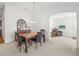 Dining area featuring a marble table, stylish seating, and open view of the adjacent living room at 5719 Spartina Ter, The Villages, FL 32163