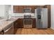 The kitchen is equipped with stainless steel appliances and laminate countertops at 5719 Spartina Ter, The Villages, FL 32163