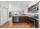 Modern kitchen with stainless steel dishwasher and stove plus plenty of cabinet space at 5719 Spartina Ter, The Villages, FL 32163