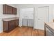 Convenient laundry room includes washer, dryer, and ample shelving for organized storage at 5719 Spartina Ter, The Villages, FL 32163