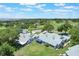 Overhead view showcasing a home's proximity to the golf course, lush greenery, and the serene lake at 6036 Topsail Rd, Lady Lake, FL 32159