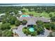 Stunning aerial view of the clubhouse, pool, and golf course at 6036 Topsail Rd, Lady Lake, FL 32159