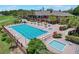 Overhead image of a large pool and jacuzzi at the clubhouse with plenty of lounge chairs for relaxing at 6036 Topsail Rd, Lady Lake, FL 32159