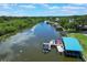 Aerial view of a canal with boat docks and lifts at 6036 Topsail Rd, Lady Lake, FL 32159