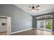 Bright bedroom with hardwood floors, ceiling fan, vaulted ceiling, slider door and transom window at 6036 Topsail Rd, Lady Lake, FL 32159