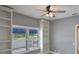 This room features built in shelves, a ceiling fan and natural light from a window with white shutters at 6036 Topsail Rd, Lady Lake, FL 32159