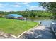 Lush view of a boat dock on the water with a boat lift at 6036 Topsail Rd, Lady Lake, FL 32159