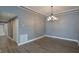 Dining room featuring hardwood floors and a chandelier for warm lighting during meals at 6036 Topsail Rd, Lady Lake, FL 32159