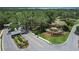 Community entrance featuring a decorative fountain, manicured landscaping, and a secure gatehouse at 6036 Topsail Rd, Lady Lake, FL 32159