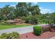 Harbor Hills Country Club entrance with decorative fountain, signage, and professionally landscaped grounds at 6036 Topsail Rd, Lady Lake, FL 32159