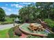 Community entrance with fountain, gatehouse, and lush landscaping creating an inviting first impression at 6036 Topsail Rd, Lady Lake, FL 32159