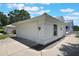 Two-car garage with white door and carriage lights, complementing the clean exterior of the home at 6036 Topsail Rd, Lady Lake, FL 32159