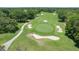 Overhead view of a well-maintained golf course with sand traps, a putting green, and manicured fairways at 6036 Topsail Rd, Lady Lake, FL 32159