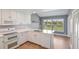 Bright kitchen with white appliances, granite countertops, and eat-in bar area at 6036 Topsail Rd, Lady Lake, FL 32159